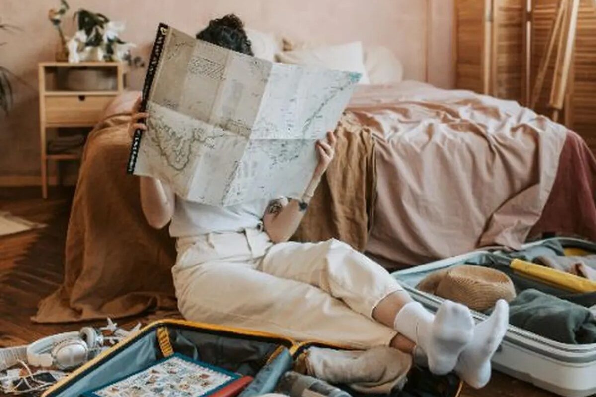 person sitting on floor reading map